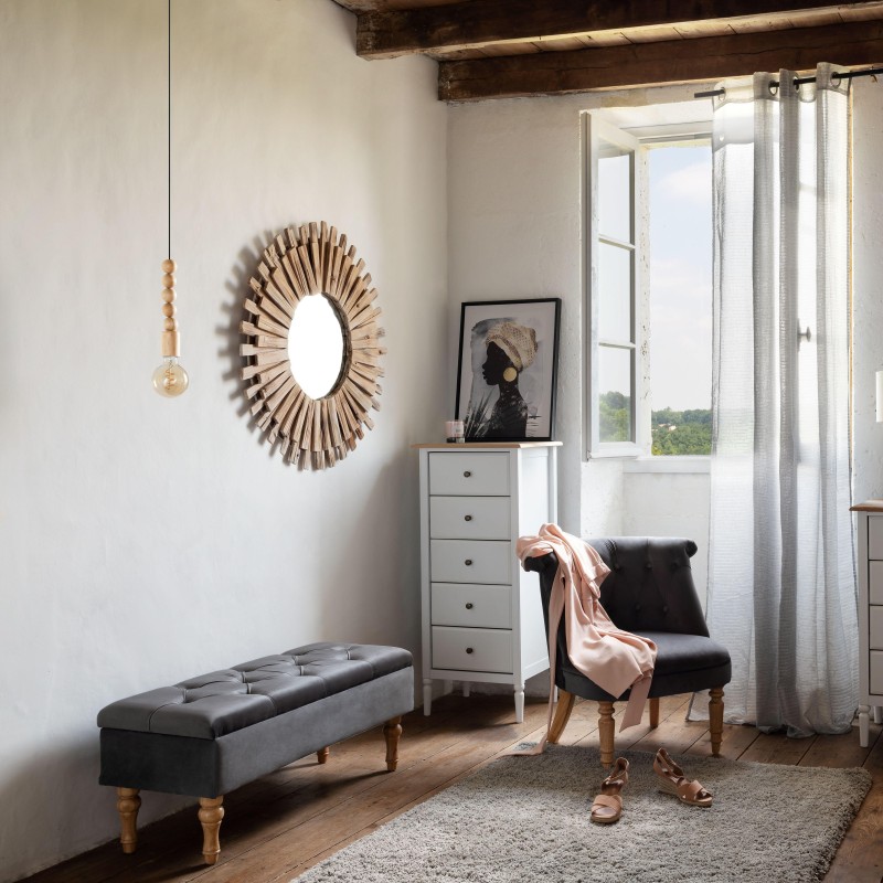 Banco tapizado en terciopelo gris oscuro con patas torneadas de madera en habitación rústica con espejo de sol de madera sillón 