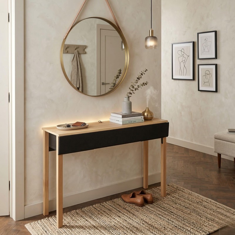 Consola recibidor con tapa de madera natural y frente negro con patas de madera en ambiente de entrada