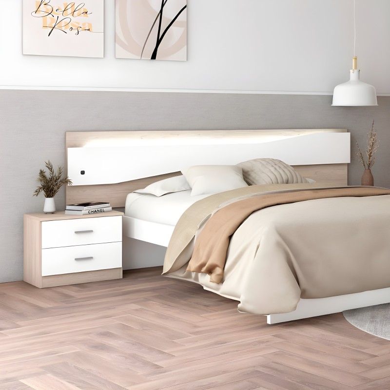 Cama matrimonial con cabecero blanco y madera natural junto a mesita de noche con cajones blancos en ambiente de dormitorio
