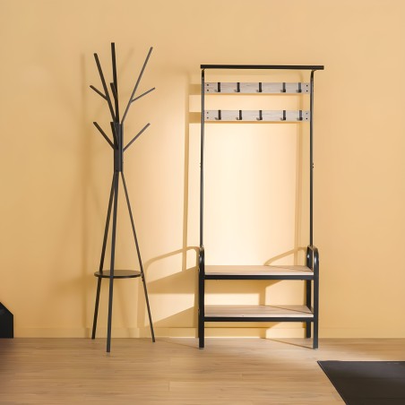 Perchero árbol negro con base circular y espejo de pared con marco negro y madera natural en ambiente