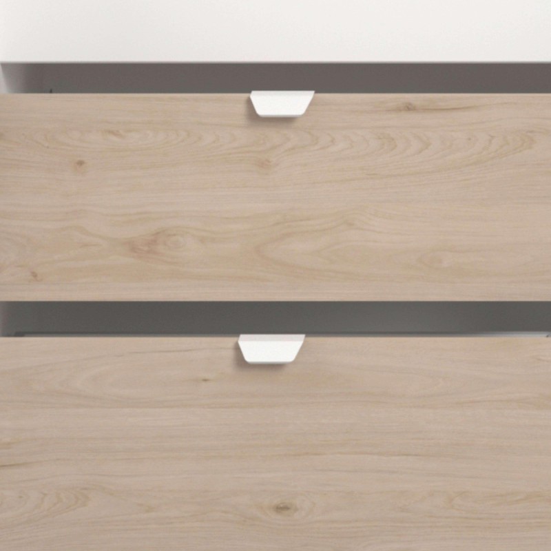 Detalle de módulo de almacenamiento con cajones de madera clara y tiradores blancos con estructura gris antracita