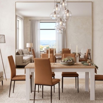 Mesa de comedor blanca con sillas de cuero marrón en ambiente luminoso y moderno