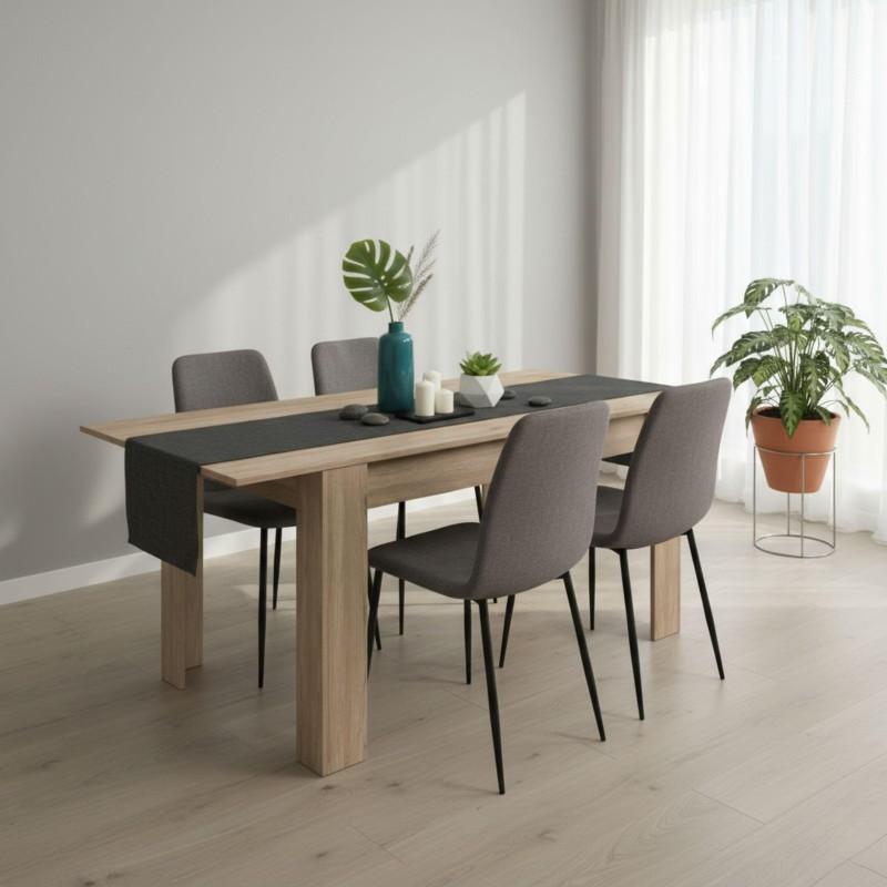 Conjunto de comedor con mesa de madera clara y tablero negro y cuatro sillas tapizadas gris oscuro con patas metálicas