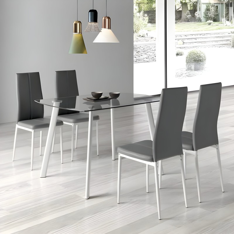Comedor con mesa de cristal y patas blancas y sillas tapizadas en gris oscuro con estructura blanca