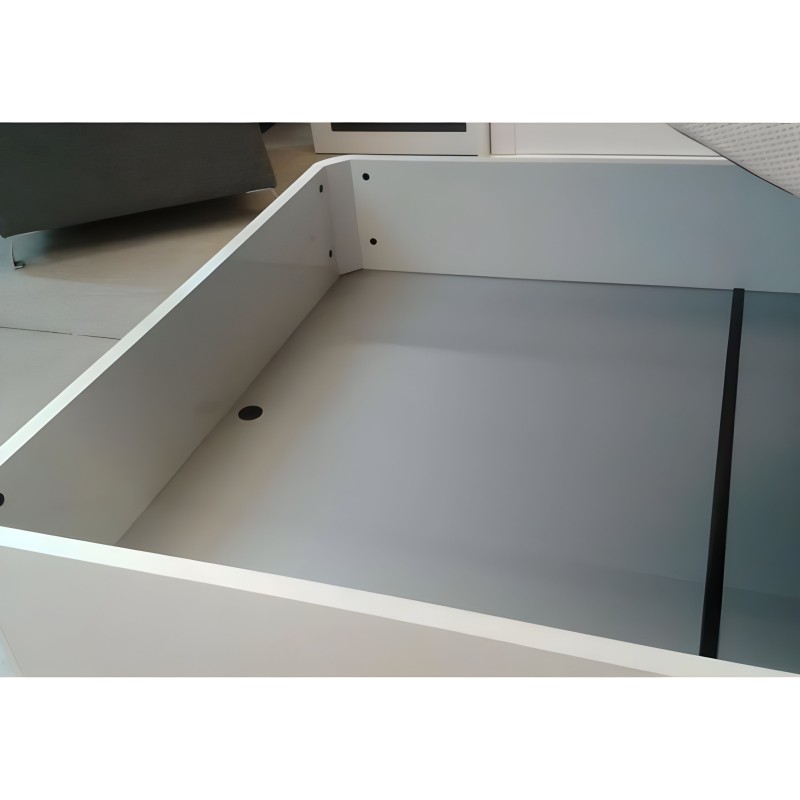 Detalle interior de cajón blanco con divisor negro y orificios de montaje